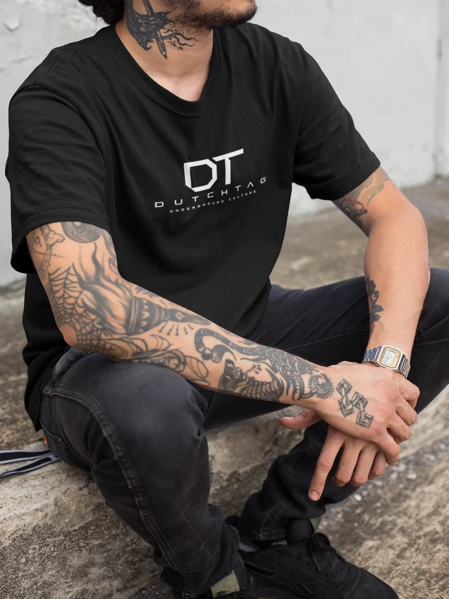Tattooed man in black t-shirt.