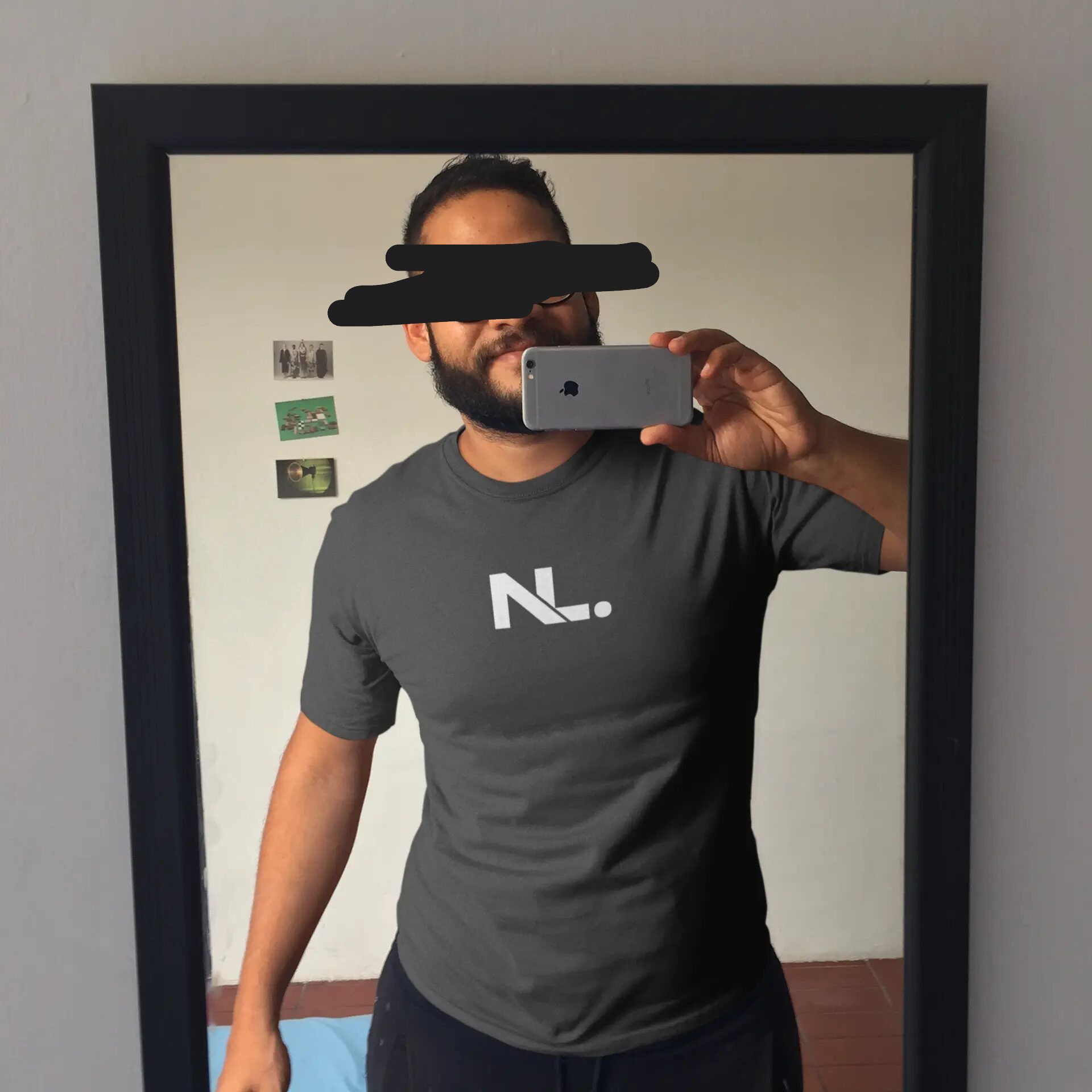 Man in gray Netherlands t-shirt taking selfie.